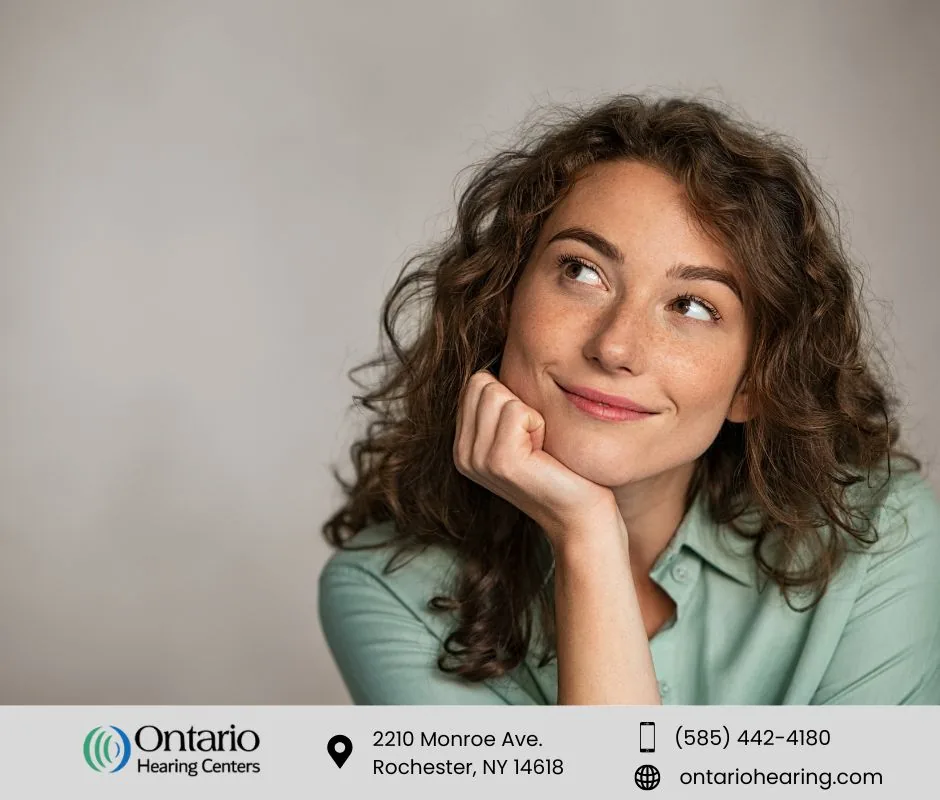 Woman with curly hair thinking about hearing aid wax guards