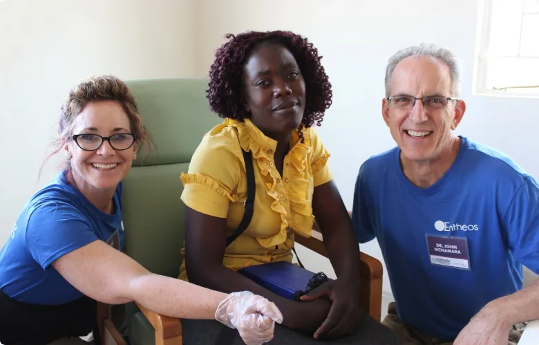 our audiologist and volunteers with patient in clinic