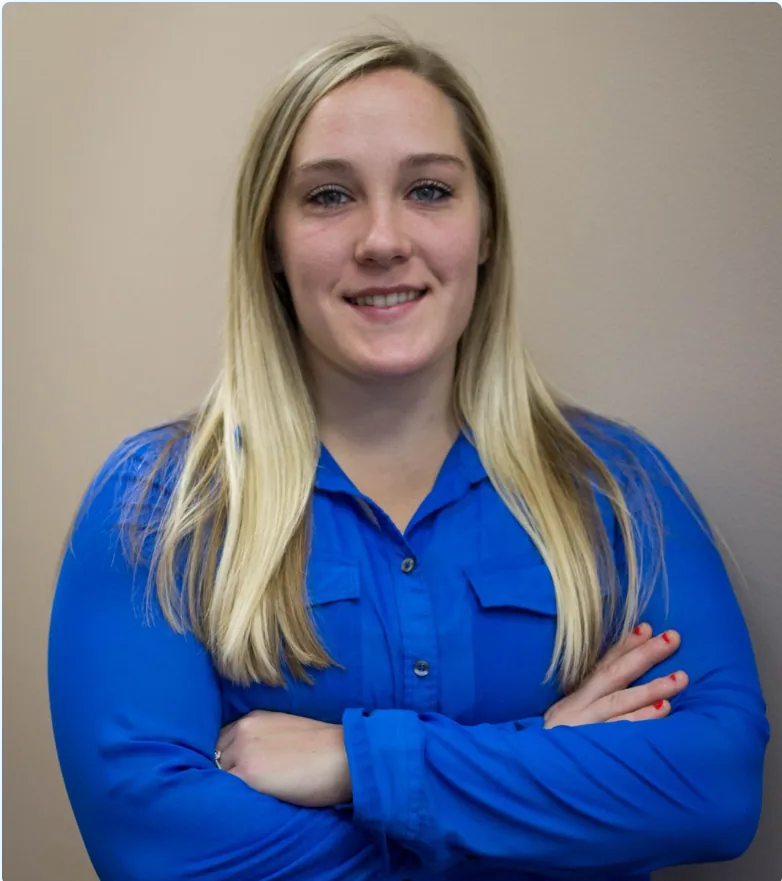 Staff headshot young woman with blonde hair in blue blouse