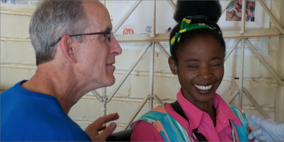 Older man and young woman smiling in clinic setting