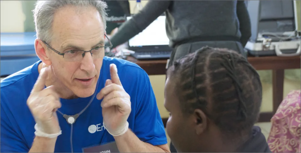 Medical professional with stethoscope speaking to child