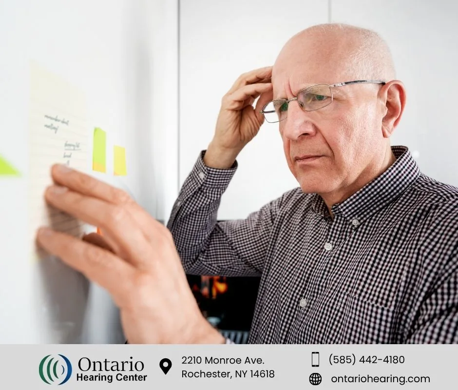Older man appearing confused while reviewing notes