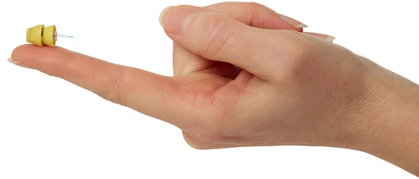 Phonak Lyric completely-in-canal hearing aid on fingertip