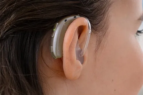Oticon Xceed super power BTE hearing aid worn on ear
