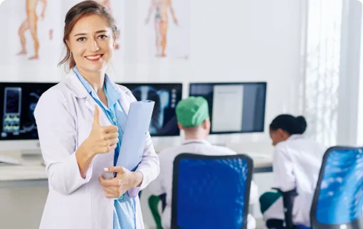 Female doctor in white coat giving thumbs up
